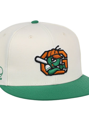 The Ebbets Field Greensboro Grasshoppers MiLB Snapback Ballcap is a white cap with a green brim and button, featuring an embroidered cartoon insect with a bat on the front and green Minor League branding on the side.