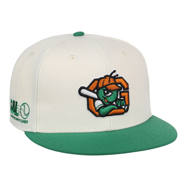 The Ebbets Field Greensboro Grasshoppers MiLB Snapback Ballcap is a white cap with a green brim and button, featuring an embroidered cartoon insect with a bat on the front and green Minor League branding on the side.