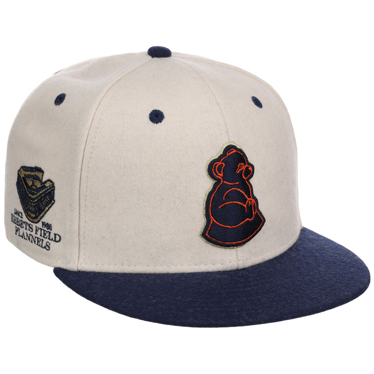 The Ebbets Field San Francisco Sea Lions NLB Ballpark Fitted Ballcap is cream with a navy brim, features an embroidered bear cub logo on the front, and a side patch reading 