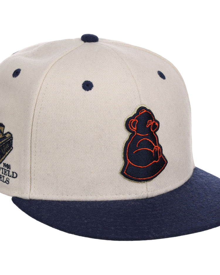 The Ebbets Field San Francisco Sea Lions NLB Ballpark Fitted Ballcap is cream with a navy brim, features an embroidered bear cub logo on the front, and a side patch reading 