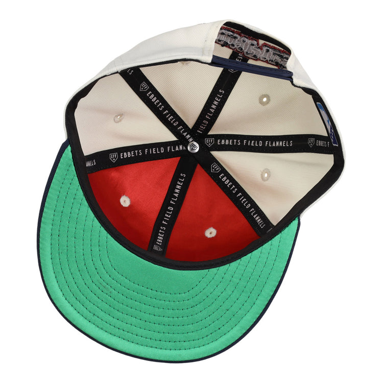 The inside of the Lehigh Valley Ironpigs MiLB Snapback Ballcap by Ebbets Field shows white and red panels, a green underbill, black taping with EBBETS FIELD FLANNELS text, and a cloth tag sewn into the sweatband.