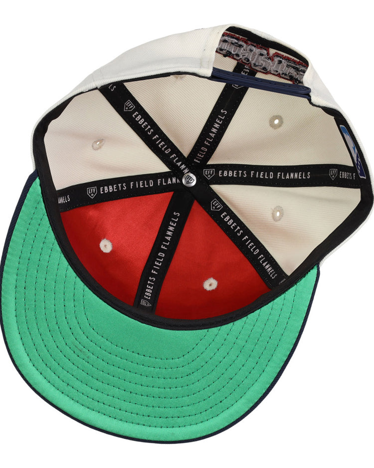The inside of the Lehigh Valley Ironpigs MiLB Snapback Ballcap by Ebbets Field shows white and red panels, a green underbill, black taping with EBBETS FIELD FLANNELS text, and a cloth tag sewn into the sweatband.