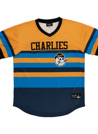 The Ebbets Field Charleston Charlies MiLB Vintage V-Neck Jersey features yellow, blue, and black stripes, CHARLIES text across the chest, and a cartoon baseball character in a yellow cap on the front.