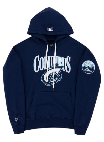 The Ebbets Field Columbus Clippers MiLB Cotton Hooded Sweatshirt is a navy blue hoodie with white drawstrings, COLUMBUS and a stylized C logo on the front, a circular 614 Class patch on the left sleeve, and a small logo near the left wrist.