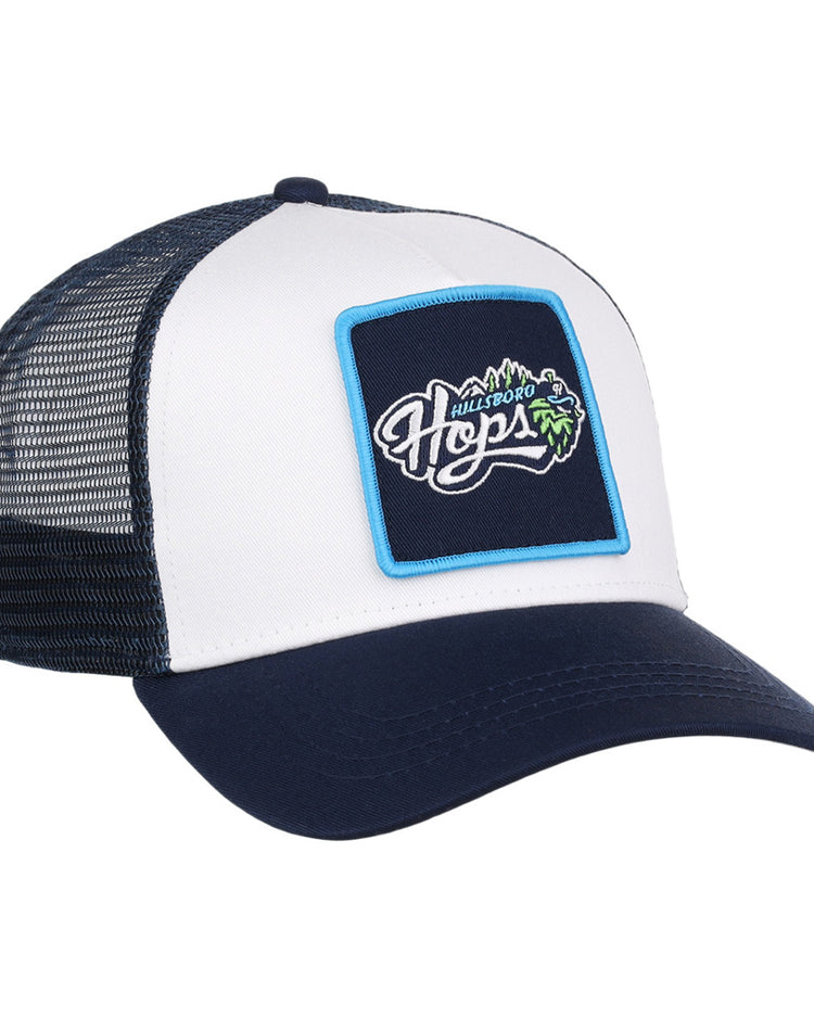 The Ebbets Field Hillsboro Hops MiLB Trucker Ballcap features a navy blue and white mesh back, plus a front patch with 