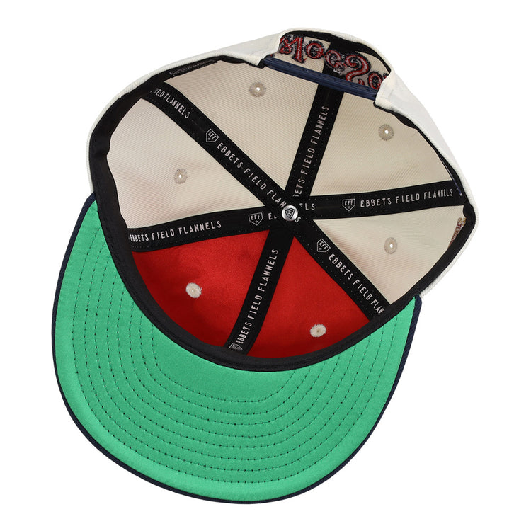 This image shows the inside of the Ebbets Field Worcester Red Sox MiLB Snapback Ballcap, featuring black cross bands with Ebbets Field branding, cream fabric panels, a green underbill, visible stitching, and a size tag.