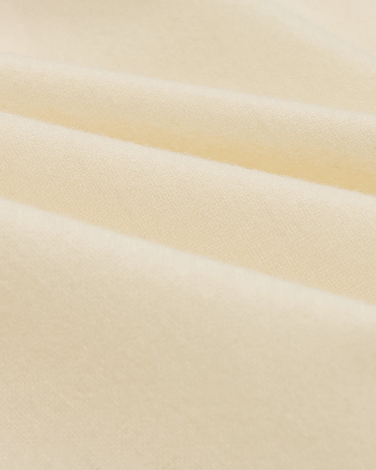 Close-up of folds in the cream-colored wool fabric of an Ebbets Field Los Angeles Angels (PCL) 1946 Authentic Wool Home Jersey.