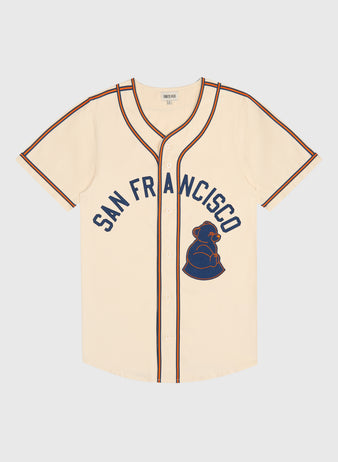 Ebbets Field San Francisco Sea Lions Cotton Twill Baseball Jersey in cream-colored cotton twill with navy and orange trim, featuring San Francisco lettering and a 1946 San Francisco Sea Lions bear logo on the front.