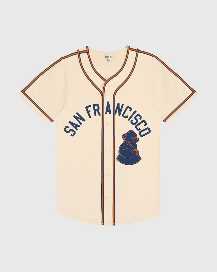Ebbets Field San Francisco Sea Lions Cotton Twill Baseball Jersey in cream-colored cotton twill with navy and orange trim, featuring San Francisco lettering and a 1946 San Francisco Sea Lions bear logo on the front.