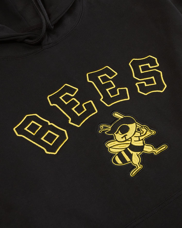 Ebbets Field Salt Lake Bees Heavyweight Cotton Terry Pullover Hoodie in black, featuring arched, yellow embroidered BEES lettering above a cartoon bee wearing a baseball cap and holding a bat.