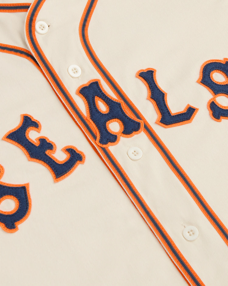 Off-white Ebbets Field San Francisco Seals 1938 Cotton Twill Jersey with orange and blue piping, featuring the word SEALS in blue felt letters outlined in orange.