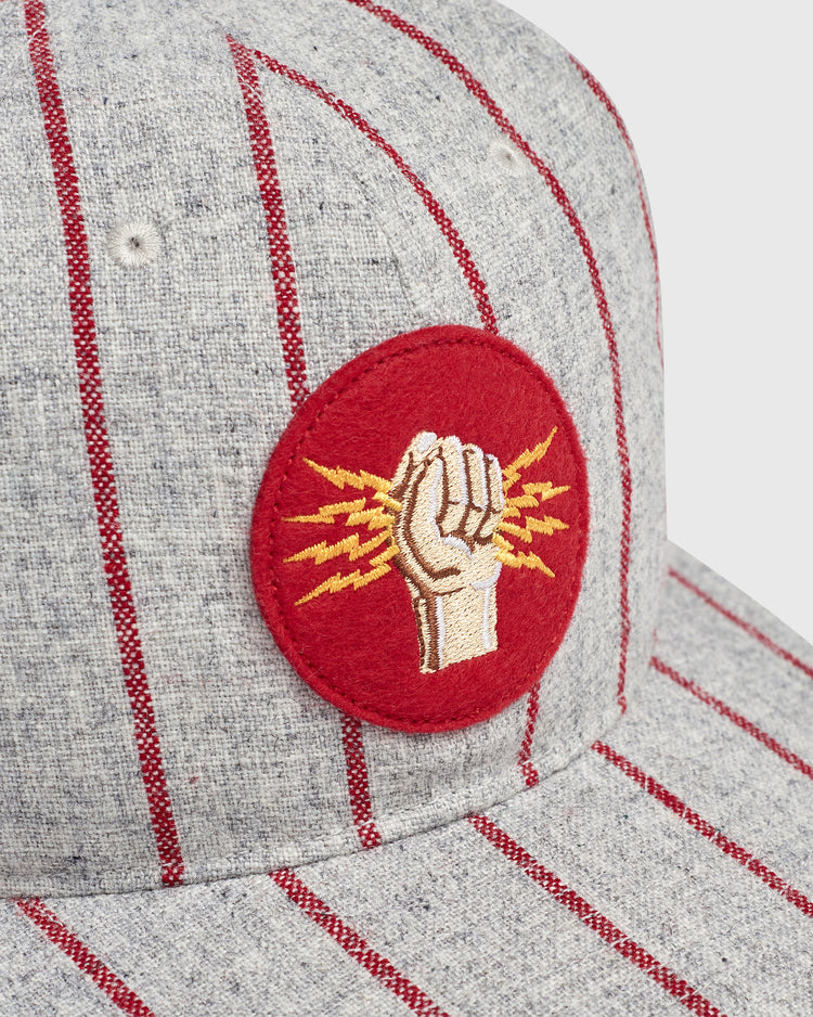 Ebbets Field Mystery Caps of Mexico – Electricistas De Necaxa 1935 Wool Ballcap in grey wool with thin red pinstripes and a circular red patch featuring an embroidered fist holding golden lightning bolts.