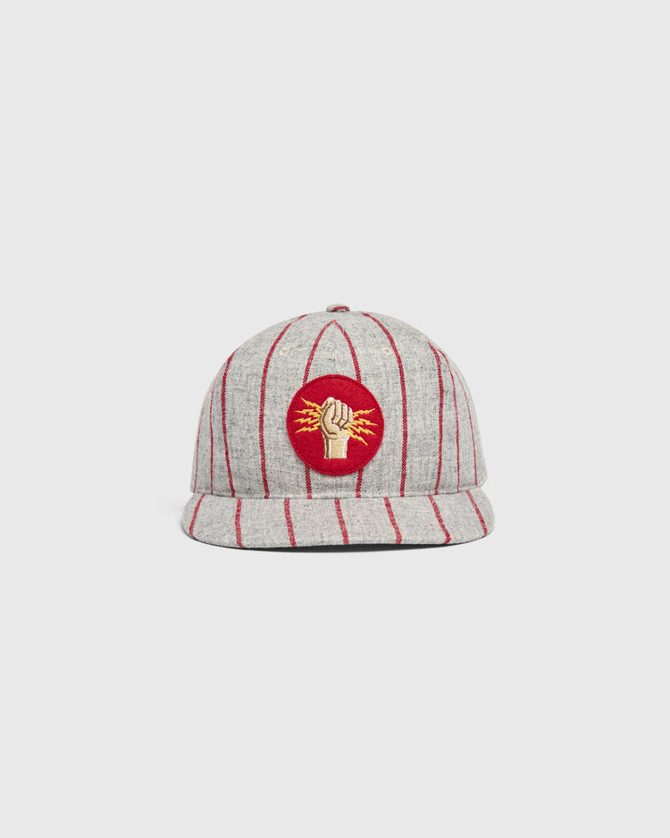 Ebbets Field Mystery Caps of Mexico – Electricistas De Necaxa 1935 Wool Ballcap in grey with red pinstripes and a circular patch on the front featuring a gold fist holding a lightning bolt on a red background.