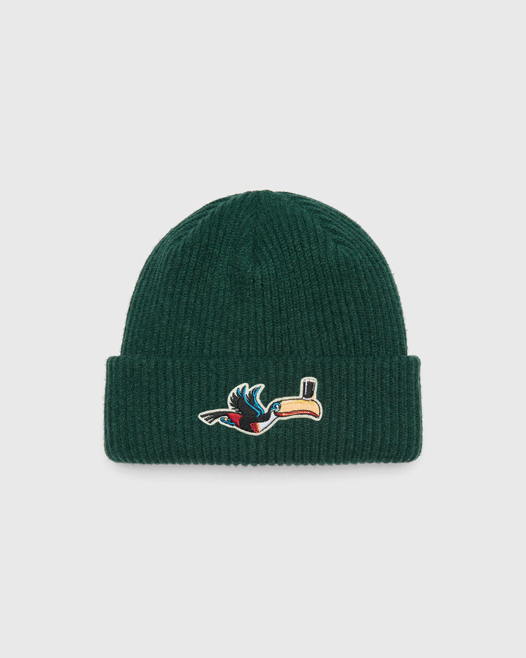 Dark green Ebbets Field Guinness Flying Toucan Felt Patch Ribbed Beanie featuring a felt patch of a Guinness toucan balancing a glass of stout on its beak.