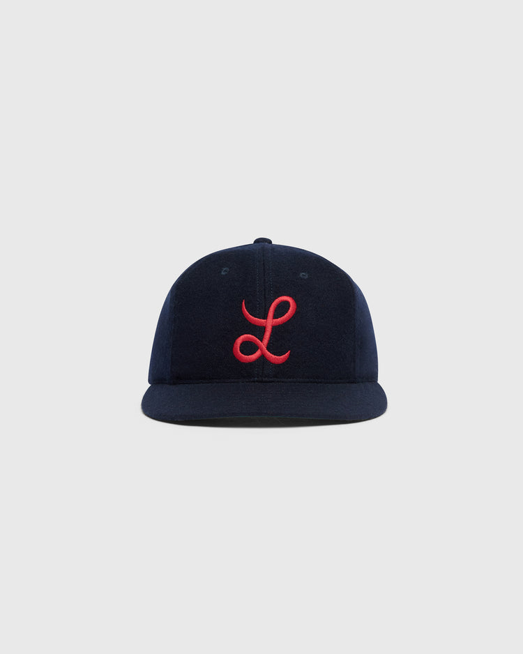Ebbets Field Mystery Caps of Mexico – La Junta de Nuevo Laredo 1940 Wool Ballcap featuring a navy blue wool design with a red embroidered cursive L on the front.