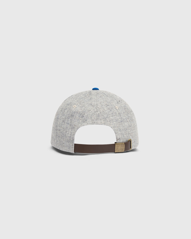 Back view of a light gray Ebbets Field Mystery Caps of Mexico – San Luis Potosi 1926 Wool Ballcap, featuring a blue button on top and an adjustable brown leather strap with a brass buckle.