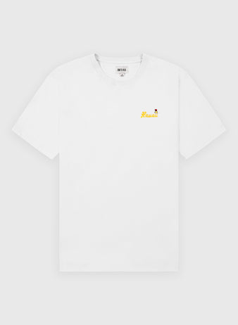 The Ebbets Field Hawaii Islanders (PCL) Embroidered ‘Hawaii’ Short Sleeve Tee features soft 200gsm cotton, with small yellow ‘Hawaii’ text and a red flower graphic on the left chest, shown on a plain light gray background.