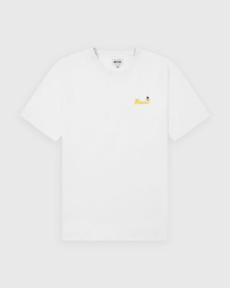 The Ebbets Field Hawaii Islanders (PCL) Graphic Short Sleeve Tee is a white shirt featuring a small yellow Hawaii text and a red flower graphic on the left chest, shown against a plain light background.