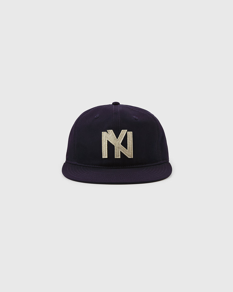 The Brooklyn Eagles Cotton Twill Ballcap by Ebbets Field, in navy, features a flat brim and a prominent silver embroidered NY logo on the front, shown against a plain white background.
