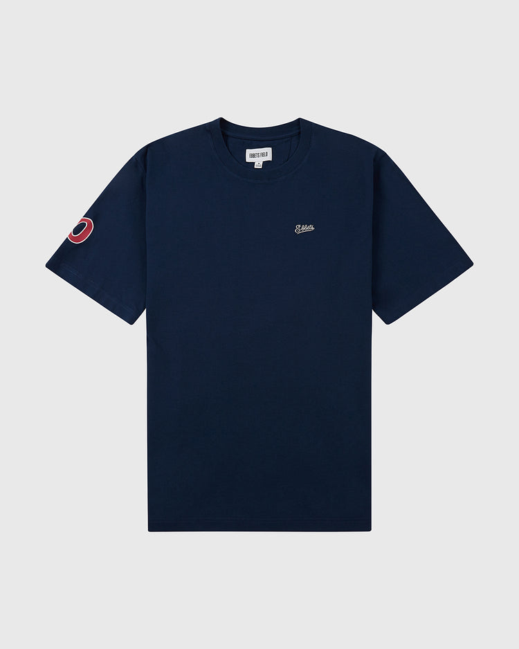 The Ebbets Field Portland Beavers Ebbets Tee with Back Print is a navy blue short-sleeve shirt featuring a small embroidered logo on the left chest and a red circular patch on the left sleeve, shown on a plain light background.
