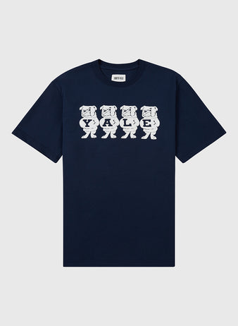 The Ebbets Field YALE SS TEE NAVY features five cartoon bulldogs holding letters to spell YALE in white across the chest. The navy blue shirt is displayed flat on a light background.