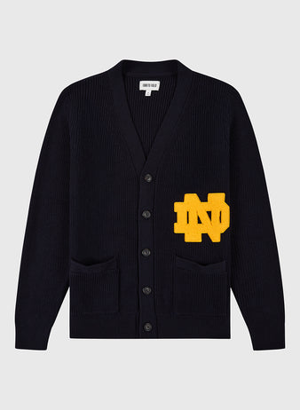 The Ebbets Field NOTRE DAME VARSITY CARDIGAN in navy features two front pockets and a bold yellow ND varsity patch on the left side.
