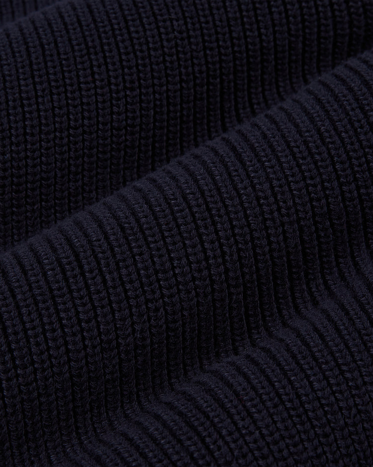 Close-up of the YALE VARSITY CARDIGAN Navy by Ebbets Field, highlighting its dark navy ribbed knit fabric with textured vertical lines and a soft, slightly raised, thick surface.