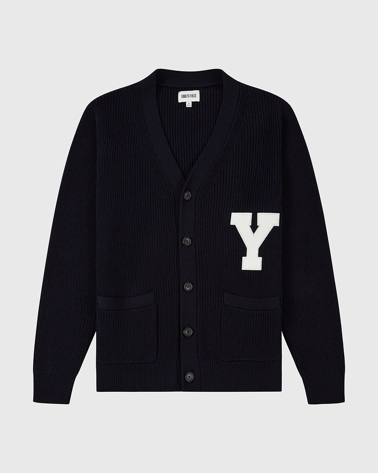 The Ebbets Field YALE VARSITY CARDIGAN Navy features a large white Y patch on the left chest, black buttons, and two front pockets. Shown against a plain light gray background.