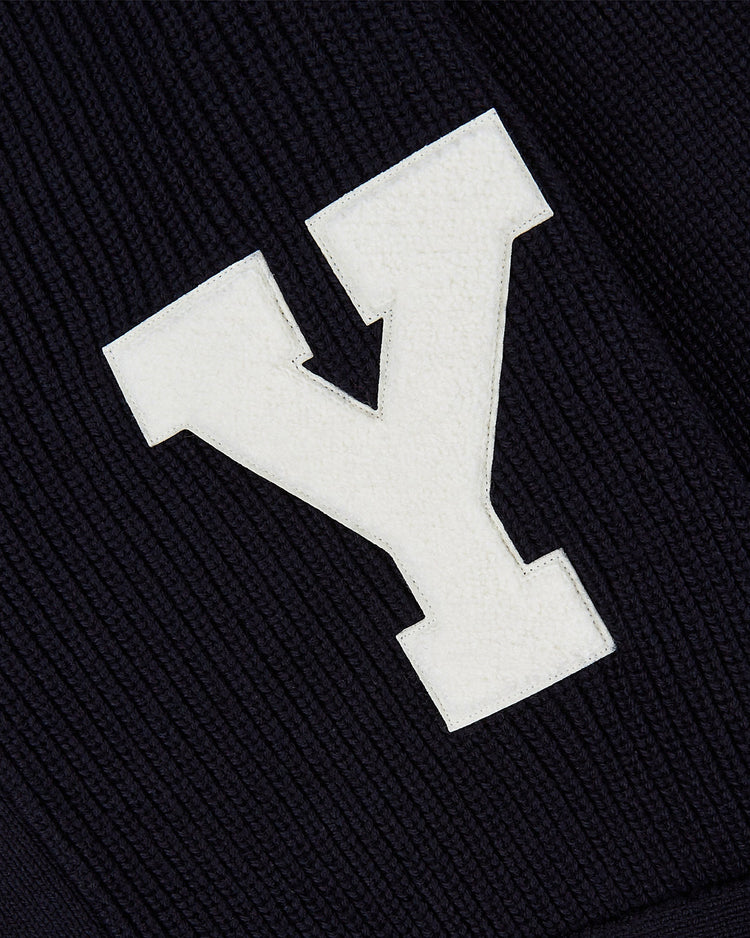 A large white letter Y is sewn onto the dark, ribbed fabric of the Ebbets Field YALE VARSITY CARDIGAN in navy.