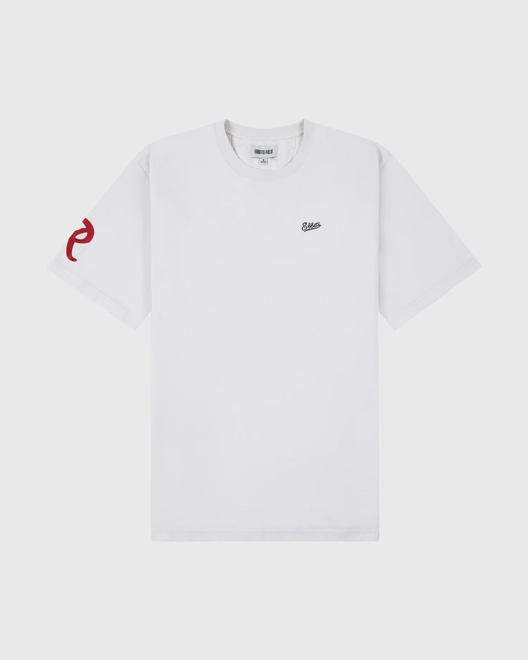 The Seattle Rainiers Ebbets Tee by Ebbets Field features a small black logo on the left chest and a red graphic on the left sleeve, showcased against a light background.