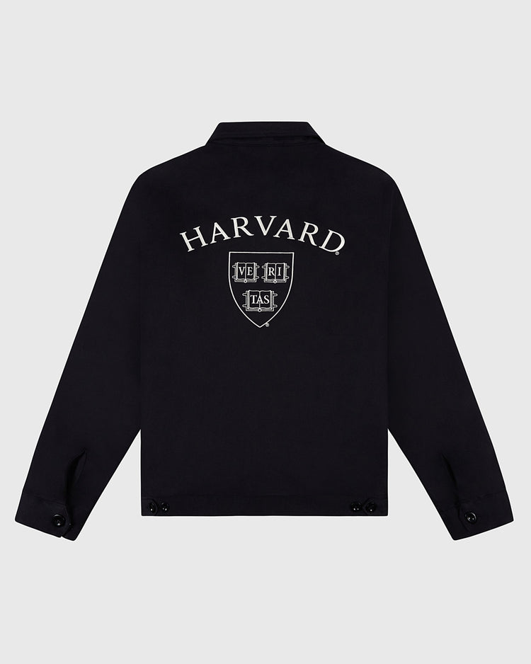 The Ebbets Field HARVARD GROUNDS CREW JACKET BLK is a black jacket with HARVARD and the university crest, including the Latin motto VERITAS, embroidered in white on the back.