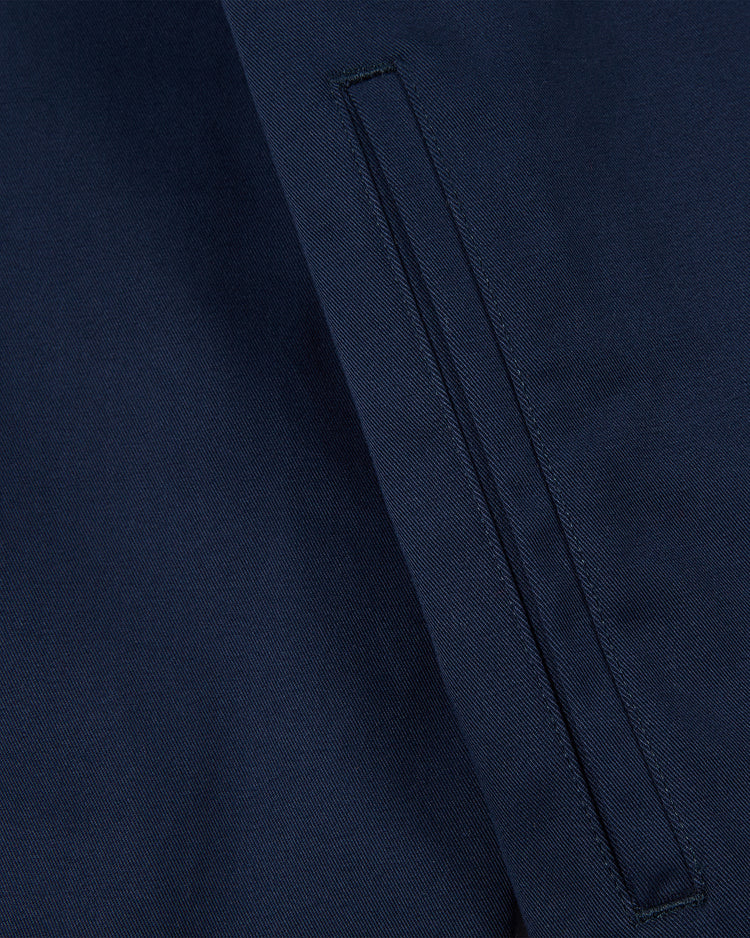 Close-up of the YALE GROUNDS CREW JACKET Navy by Ebbets Field, showing a neatly sewn horizontal welt pocket with visible stitching details on the navy blue fabric, highlighting the jackets tailored craftsmanship.