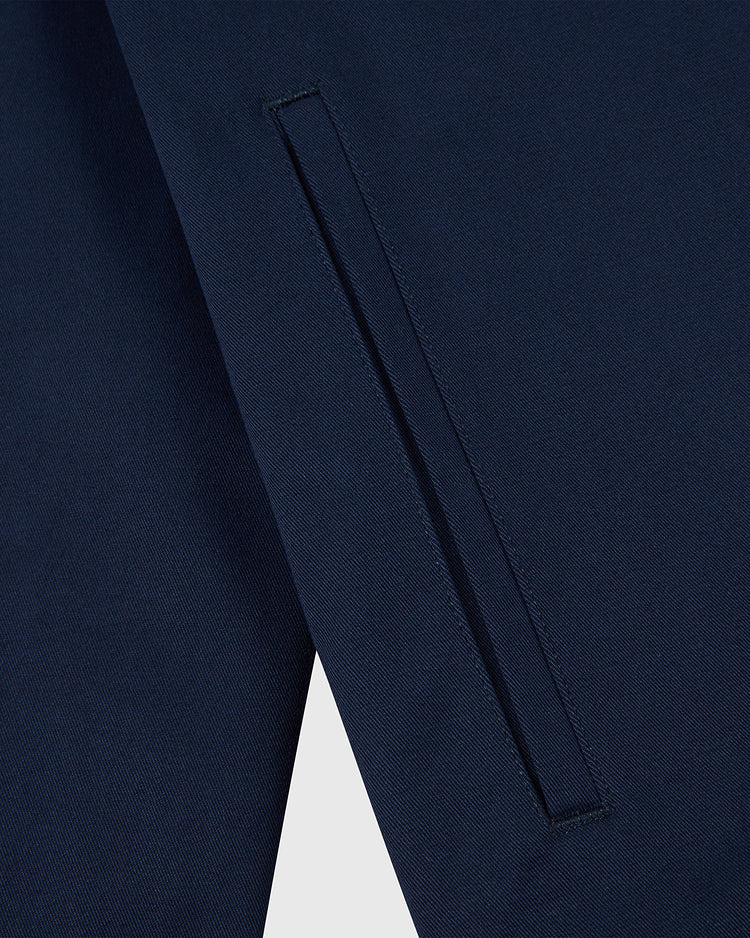 Close-up of the Ebbets Field NOTRE DAME GROUNDS CREW JACKET in Navy, highlighting a neatly sewn vertical slit pocket with clean lines and smooth fabric texture.