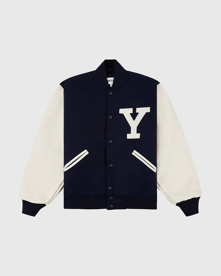 The YALE VARSITY JACKET Navy by Ebbets Field features white sleeves, ribbed cuffs, a large white Y patch on the chest, two white-trimmed pockets, and front snap buttons.