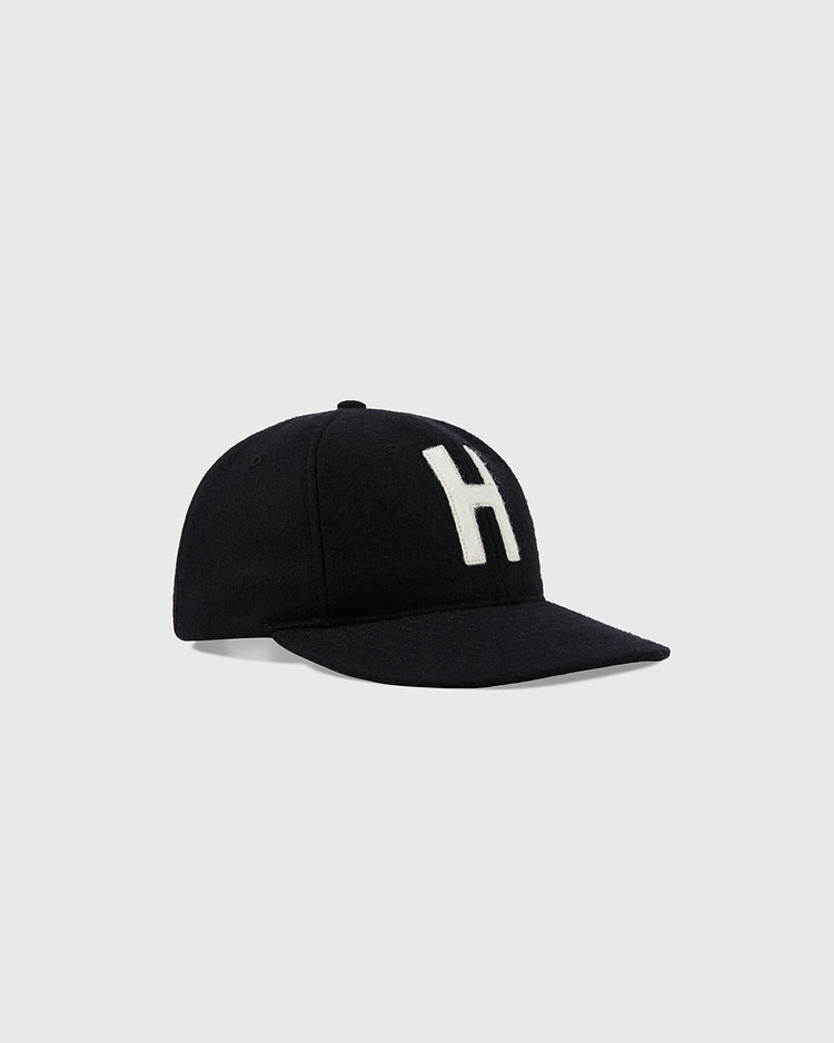 The Harvard University 1950 Authentic Wool Ballcap BLK by Ebbets Field features a black design with a white H on the front, shown against a plain light gray background.