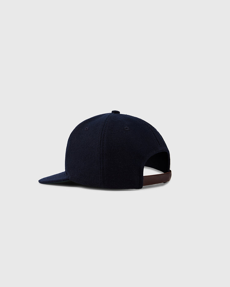 The Ebbets Field Flannels University of North Carolina 1960 Vintage Ballcap is shown from the back, navy blue wool with a curved brim and adjustable brown strap, set against a plain light gray background.