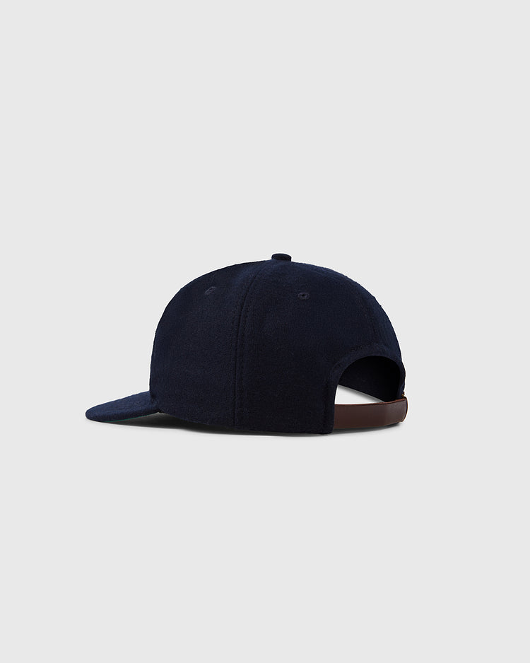 The EFF University of Connecticut 1957 Vintage Ballcap is navy blue with a curved brim and adjustable brown strap, shown from the back against a light gray background—a classic, timeless style.