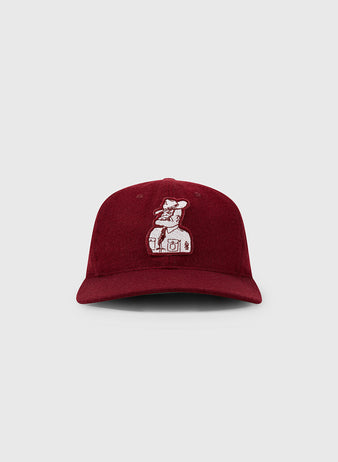 The EFF Texas A&M Aggies Mascot Collegiate Wool Ballcap in burgundy has a vintage look with an embroidered bear standing on a washing machine, shown against a plain light gray background.
