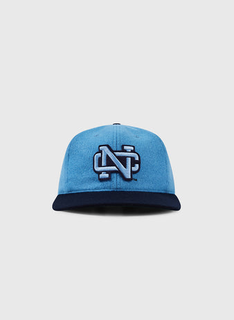 The EFF University of North Carolina 1983 Vintage Ballcap showcases a bold, white-outlined N logo on the front, blue crown with navy brim, and is displayed on a plain light gray background.