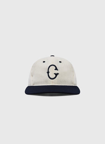 The EFF University of Connecticut Huskies Vintage Ballcap features a cream color, dark navy brim, and bold navy G inspired by the Yankee Conference, shown against a white background.