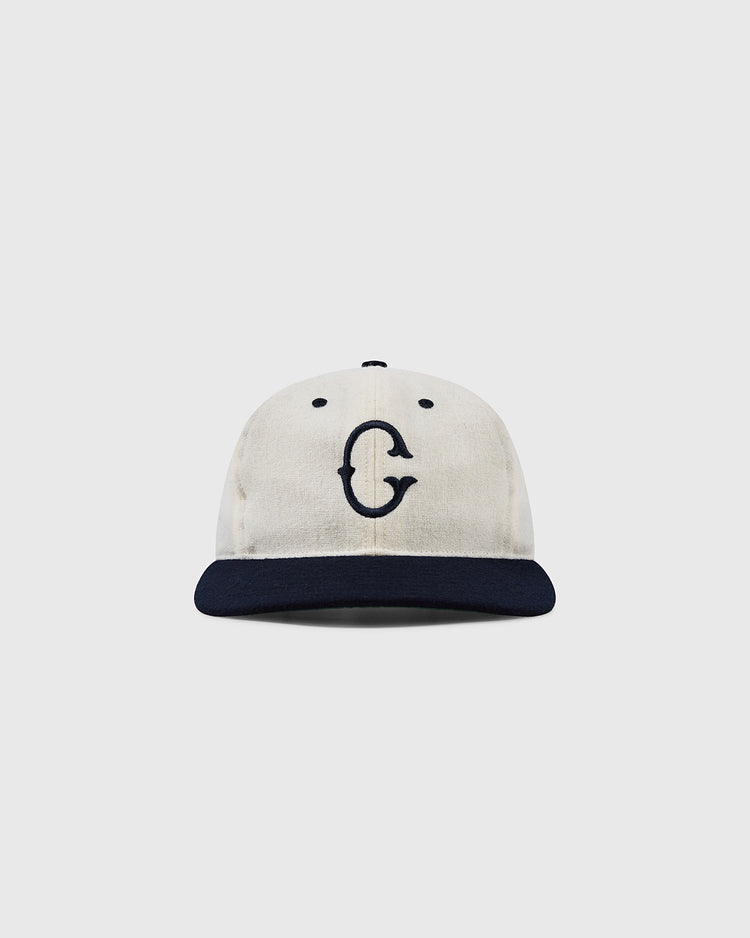 The EFF University of Connecticut Huskies Vintage Ballcap features a cream color, dark navy brim, and bold navy G inspired by the Yankee Conference, shown against a white background.