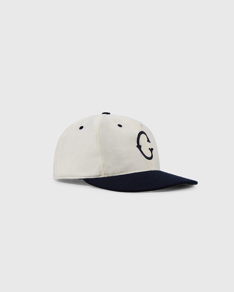The EFF University of Connecticut 1957 Authentic Wool Ballcap features a cream color, navy brim, and a bold embroidered C on the front, displayed against a plain light background.