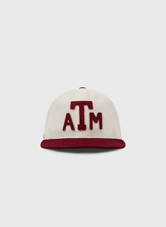 The Texas A&M Aggies Collegiate Wool Ballcap by EFF is a vintage white wool cap with a maroon brim and maroon ATM letters on the front, shown against a plain light gray background.