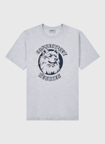 The Ebbets Field UCONN SS TEE H-GRY is a light gray T-shirt with a husky dog head graphic centered, and “Connecticut Huskies” in bold capital letters arching above and below.