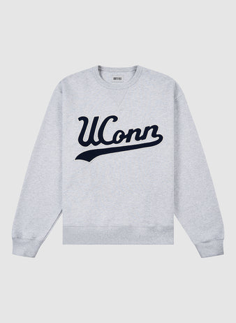 The Ebbets Field UCONN CREWNECK SS H-GRY is a light gray sweatshirt featuring UConn in large navy blue script across the chest, displayed flat on a white background.