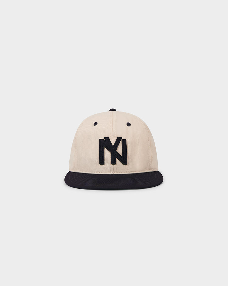 The Ebbets Field Brooklyn Eagles 1935 Cotton Twill Ballcap features a beige crown, black brim, and bold black NY logo embroidered on the front, shown against a plain white background.
