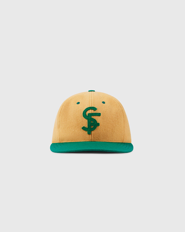 The EFF University of San Francisco Collegiate Wool Ballcap in gold, featuring a green brim and an embroidered C and S logo, is shown against a plain white background.