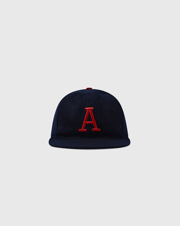 The EFF University of Arizona 1963 Vintage Ballcap features navy blue wool and a red, uppercase A on the front, shown against a light gray background. A must-have for Wildcats fans inspired by the classic 1963 cap.
