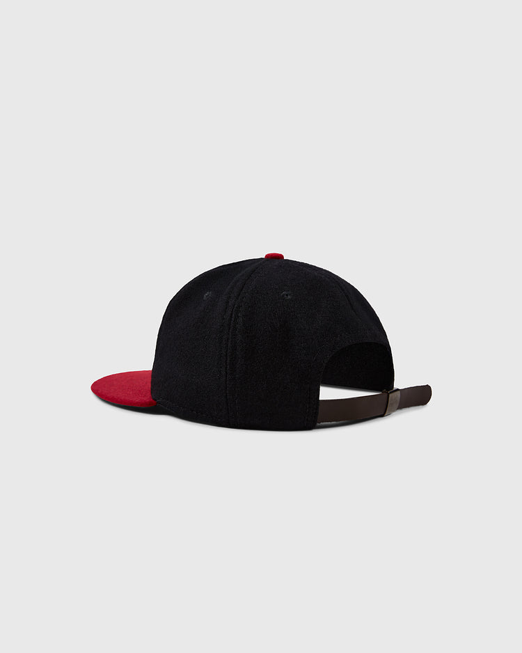 The Texas Tech University 1956 Vintage Ballcap by Ebbets Field Flannels is shown from the back in black with a red brim on a light gray background, featuring an adjustable brown strap and metal buckle for a timeless look.