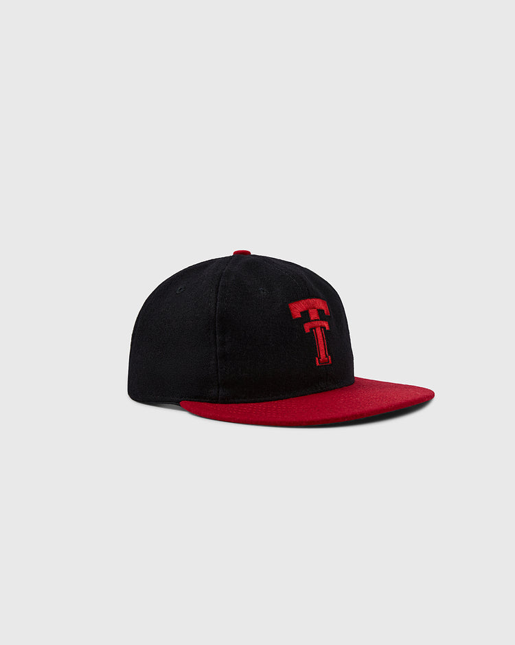 The Ebbets Field Flannels Texas Tech University 1956 Vintage Ballcap features a black crown, red brim, and a red embroidered T logo on the front, shown against a light gray background.